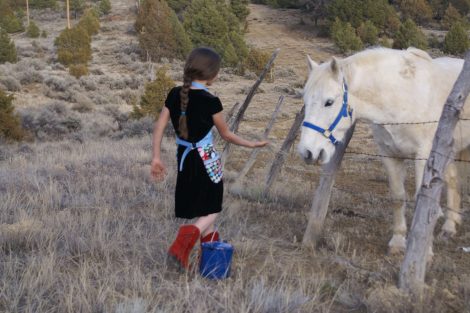girl in red boots with white horse