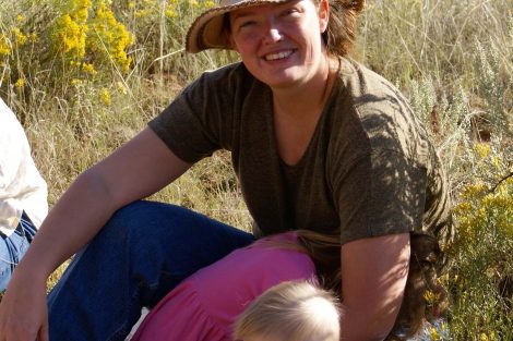 Beka outside in sunshine with a hat on.