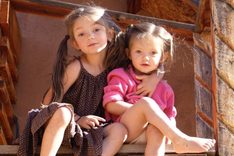 two girls together on a step